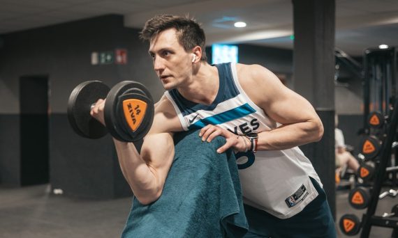 a man lifting a dumbbell in a gym